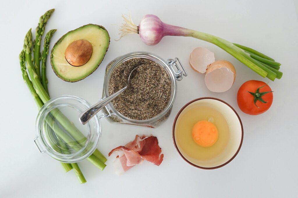 pexels photo 106877 106877 Flat lay of fresh asparagus, avocado, egg, tomato, and more for a keto-friendly dish.